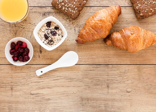 Croissants with cherries oats and copy space