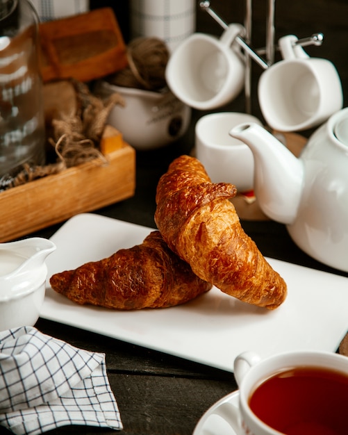 Free photo croissants with cup of tea