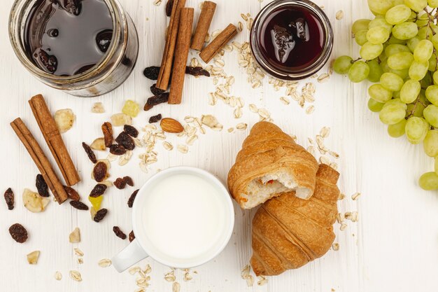 Croissants with grapes and jam in the table