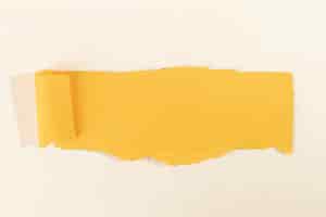 Free photo crooked yellow strip of paper on a pale rose background