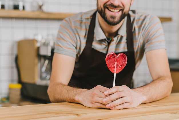 Crop bartender with lollipop