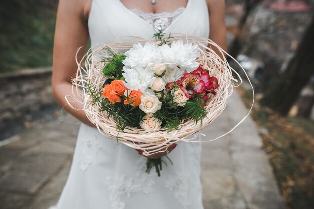 Crop bride holding bouquet