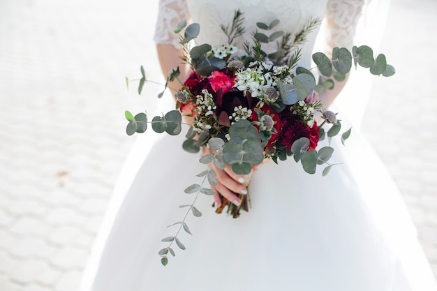 Crop bride with lush bouquet