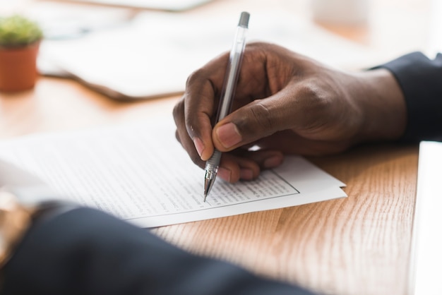 Free photo crop businessman signing papers