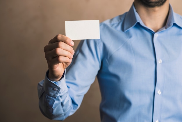 Crop businessman with card