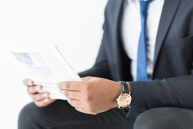 Free photo crop businessman with newspaper