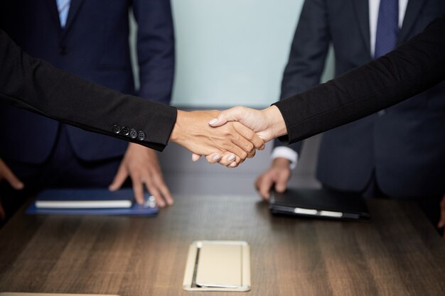 Crop businesspeople shaking hands