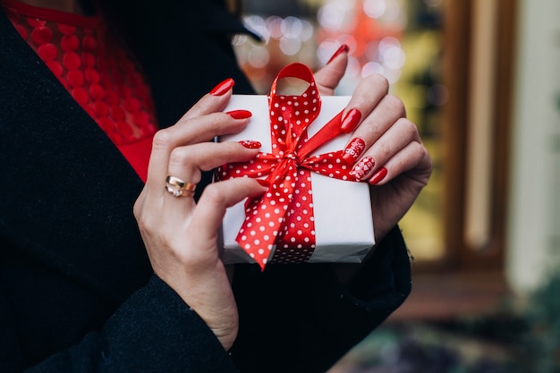 Crop content woman with Christmas present