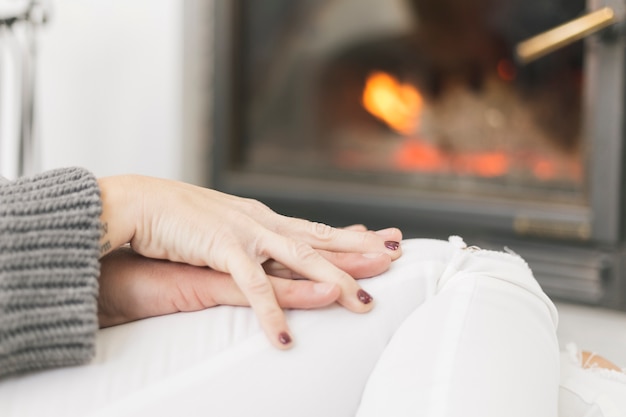 Crop couple caressing with hands