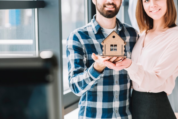 Crop couple demonstrating house