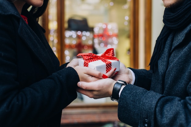 Free photo crop couple exchanging with present