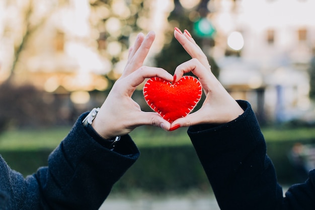 Crop couple holding crafty heart