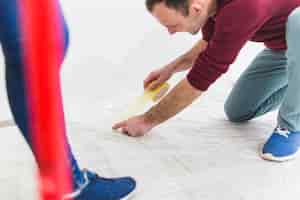 Free photo crop couple protecting floor with sheet