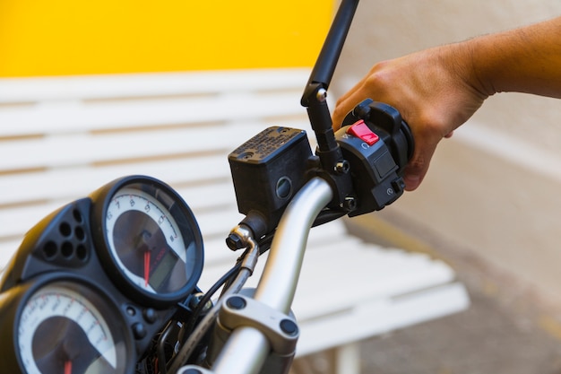 Free photo crop driver pushing handle on motorbike