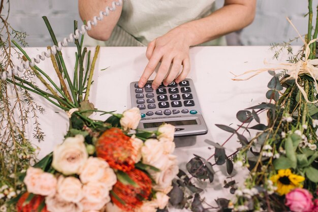 Crop employee of floristry taking order