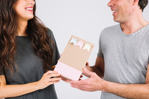 Crop father receiving gift from daughter