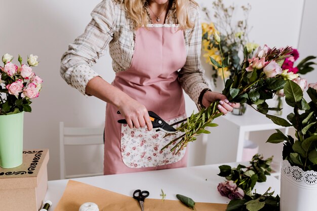 Crop florist making bouquet