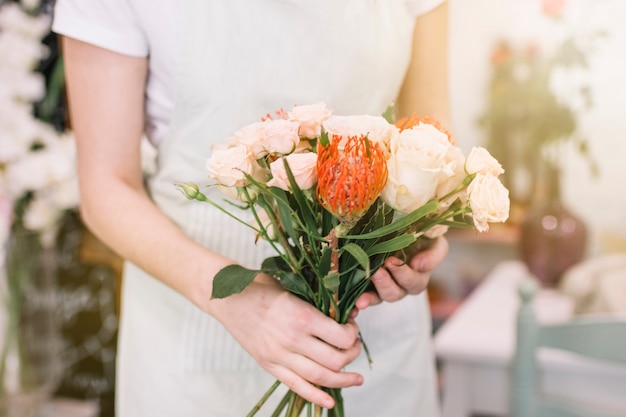 Crop florist with nice bouquet