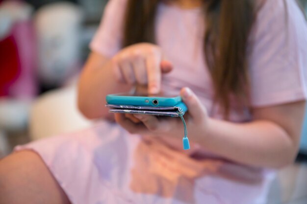 Crop girl browsing smartphone