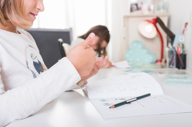 Free photo crop girl counting while doing homework