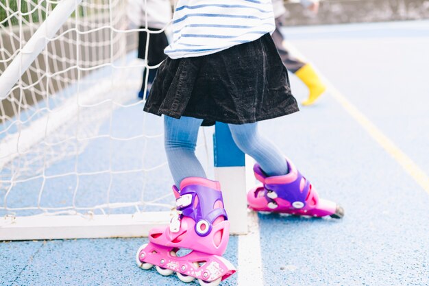 Free photo crop girl on roller skates near net