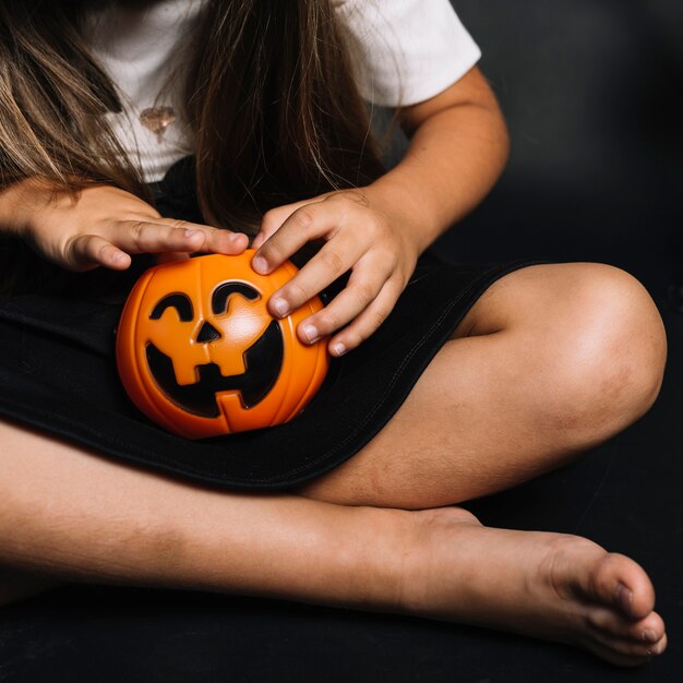 Crop girl with trick or treat basket