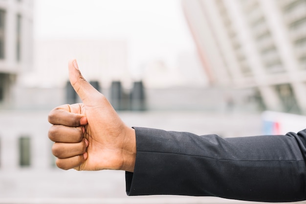 Crop hand of African-American gesturing thumb up