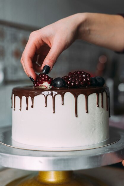 Crop hand decorating cake