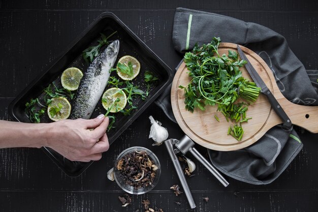 Crop hand decorating fish