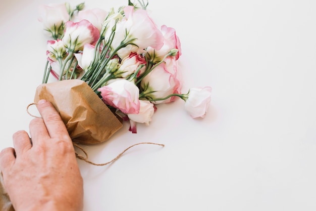 Free photo crop hand holding blooming bouquet