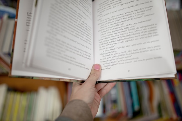 Free photo crop hand holding book