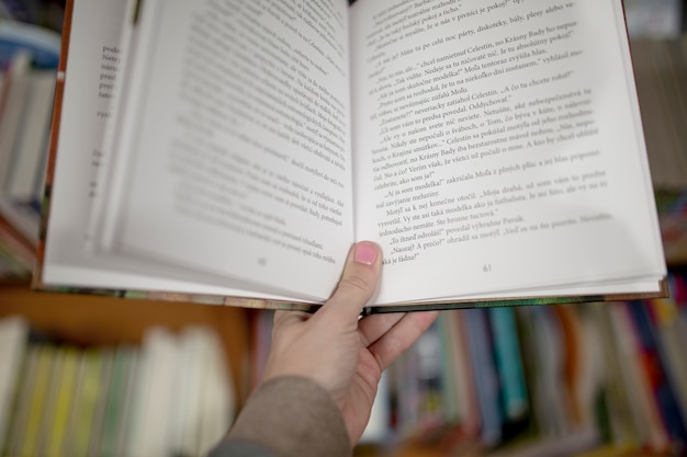 Crop hand holding book