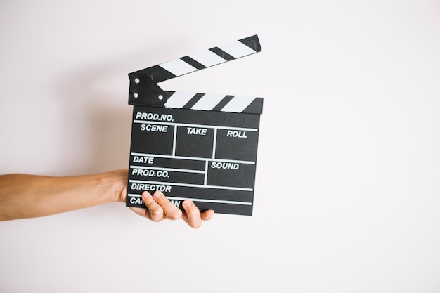 Free photo crop hand holding clapperboard