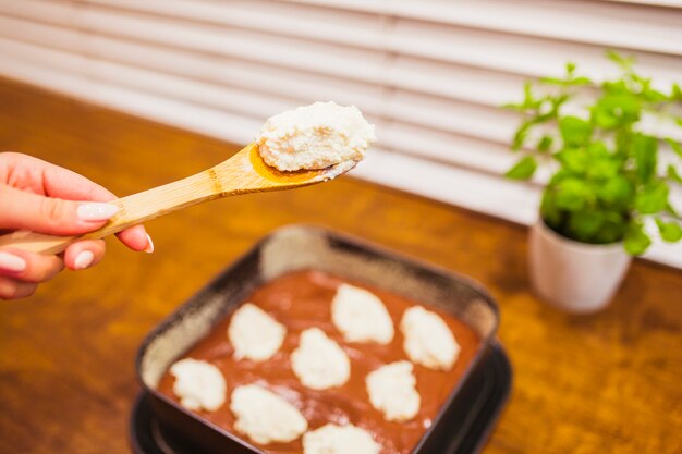 Crop hand holding dough for cake decoration