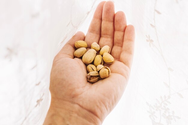 Crop hand holding nuts