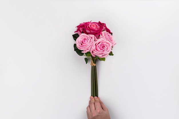 Crop hand holding rose bouquet