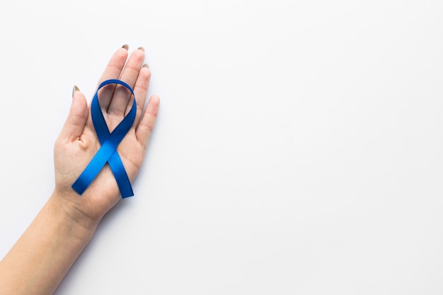 Free photo crop hand with colon cancer ribbon
