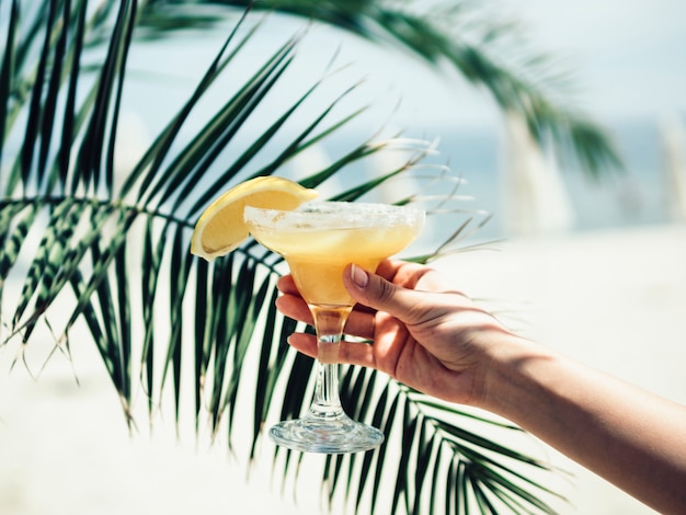 Crop hand with glass of cool drink 