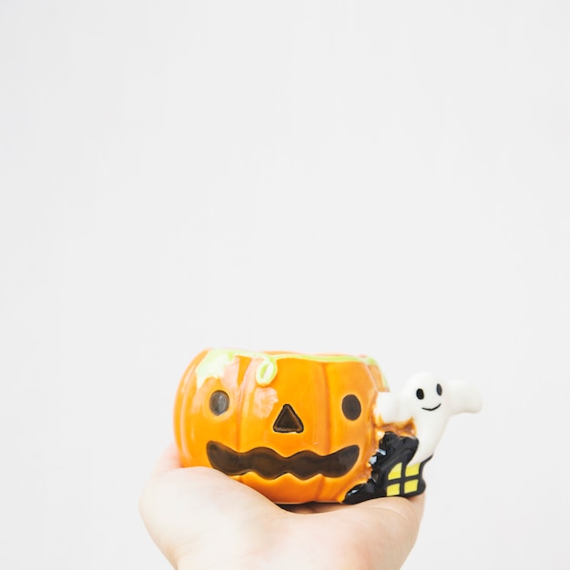 Free photo crop hand with jack-o-lantern