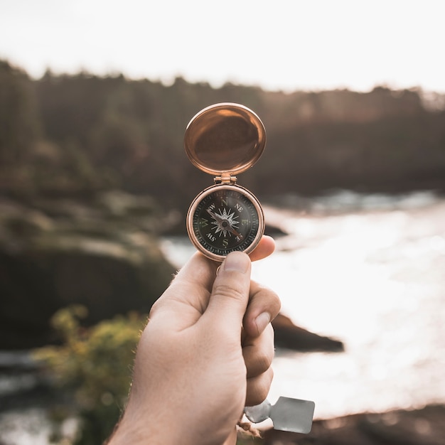 Free photo crop hand with vintage compass