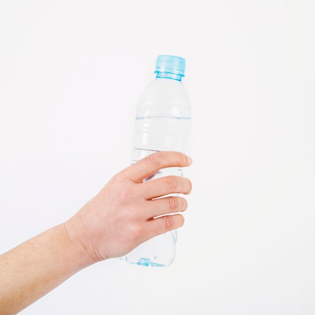 Crop hand with water bottle