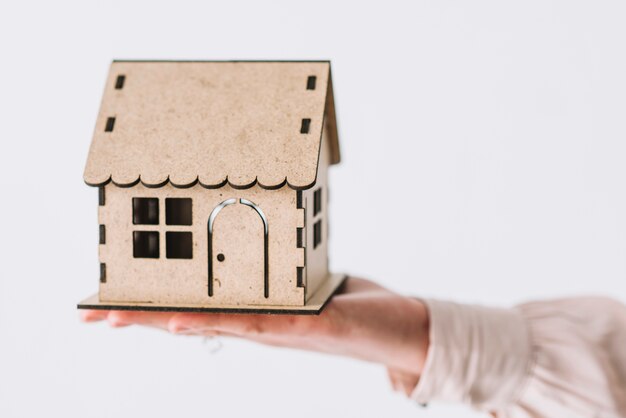 Crop hand with wooden house