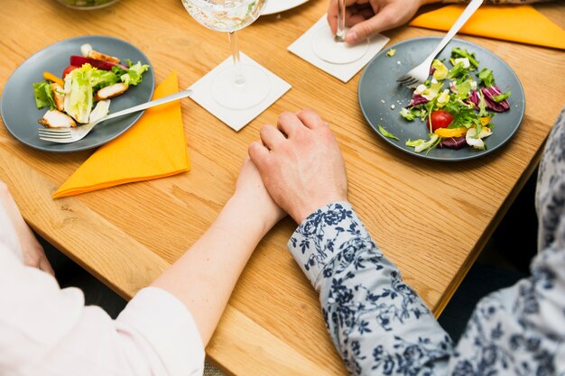 Crop hands of couple in love