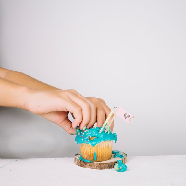 Free photo crop hands crushing cupcake