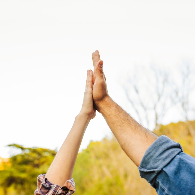 Crop hands giving high-five