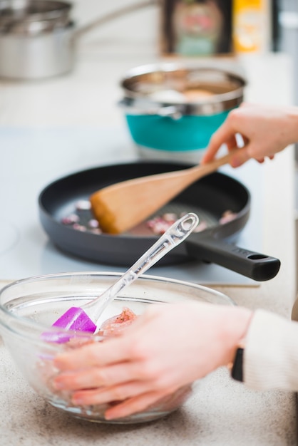 Crop hands holding bowl and mixing food