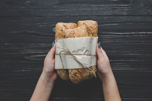 Crop hands holding bunch of buns