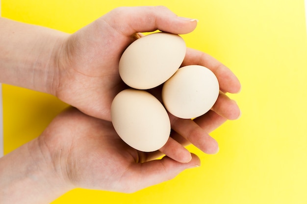 Crop hands holding eggs