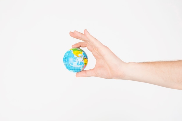 Crop hands holding little globe