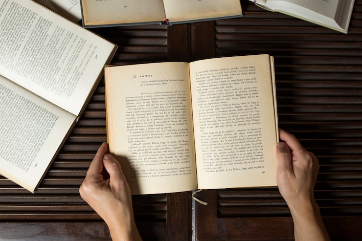 Free Photo crop hands holding opened book